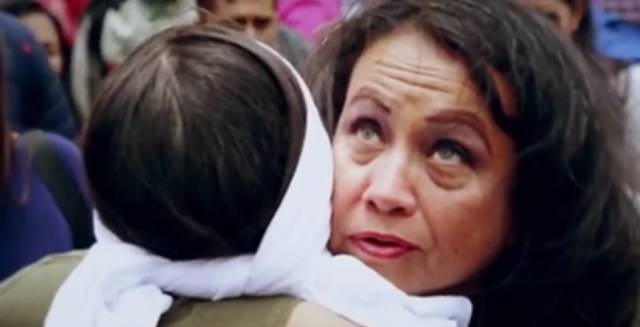 Esperanza, left, receives a hug.