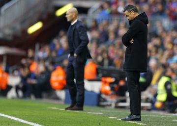 Barcelona's head coach Luis Enrique, right, looks down during the Spanish La Liga soccer match between FC Barcelona and Real Madrid at the Camp Nou stadium in Barcelona, Spain, Saturday, Dec. 3, 2016. The match ended in a 1-1 draw. (AP PhotoFrancisco Seco)