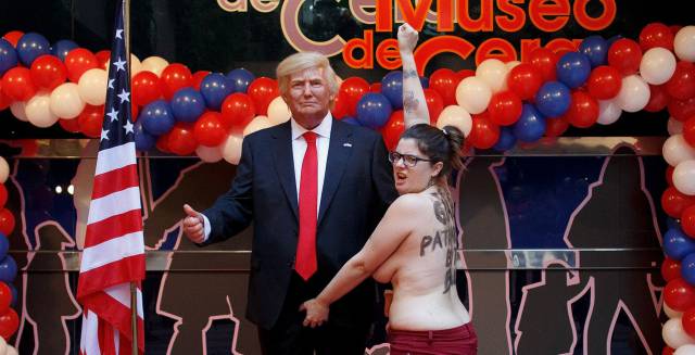Femen activist with Trump waxwork.