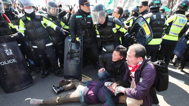 Una mujer en el suelo durante la protesta en Seúl.