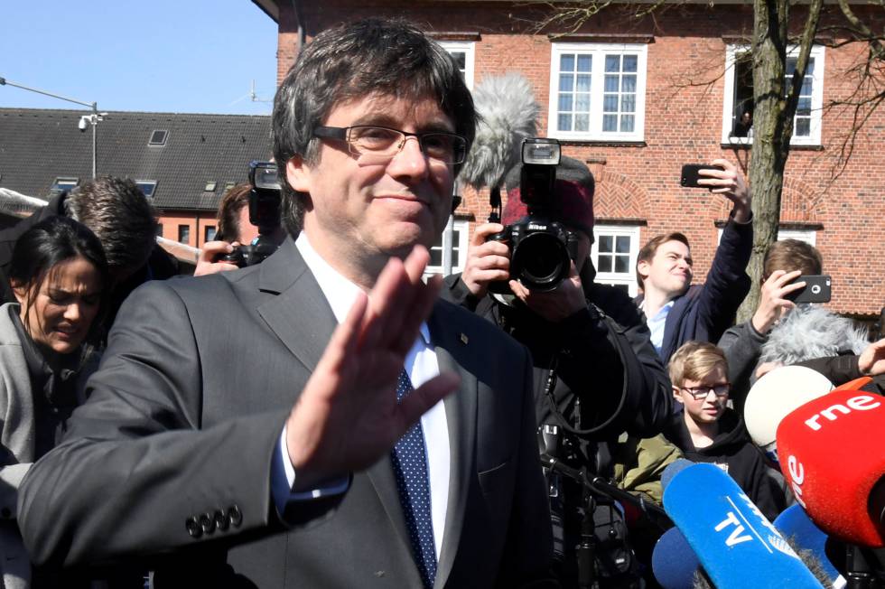 Cataloniaâ€™s former premier Carles Puigdemont greets the media as has leaves prison in Neumuenster, Germany on Friday.