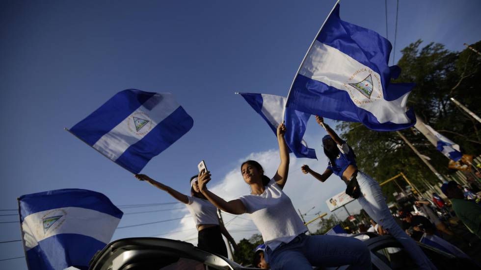 Un grupo de estudiantes agitan banderas nicaragüenses durante las protestas congra el Gobierno de Daniel Ortega.