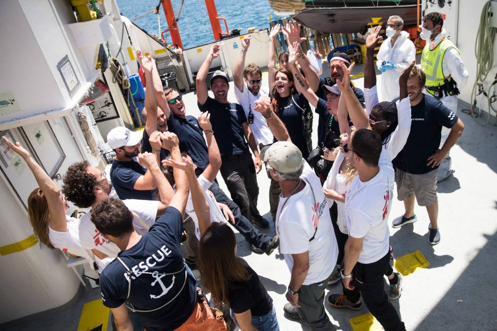 Rescue team members celebrate their arrival in Valencia.