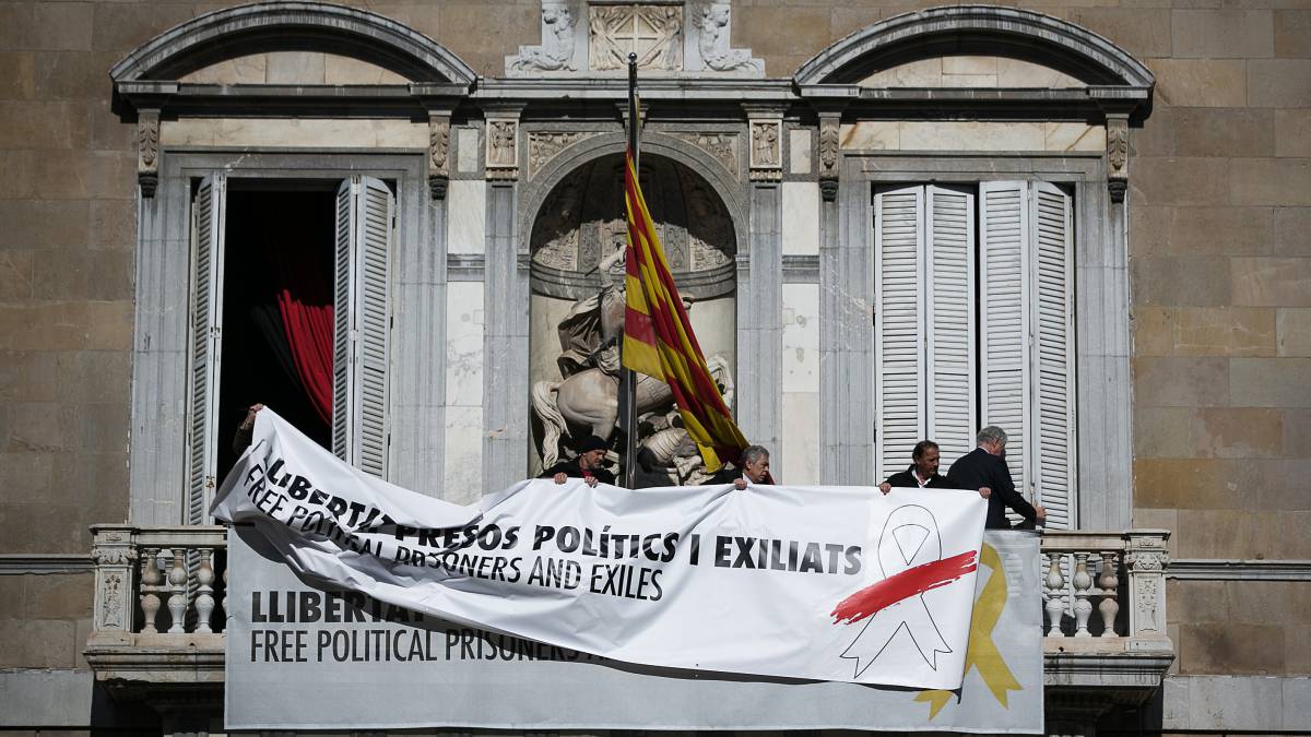 Momento en el que se tapa la pancarta con el lazo amarillo con otra en el balcón de la Generalitat.