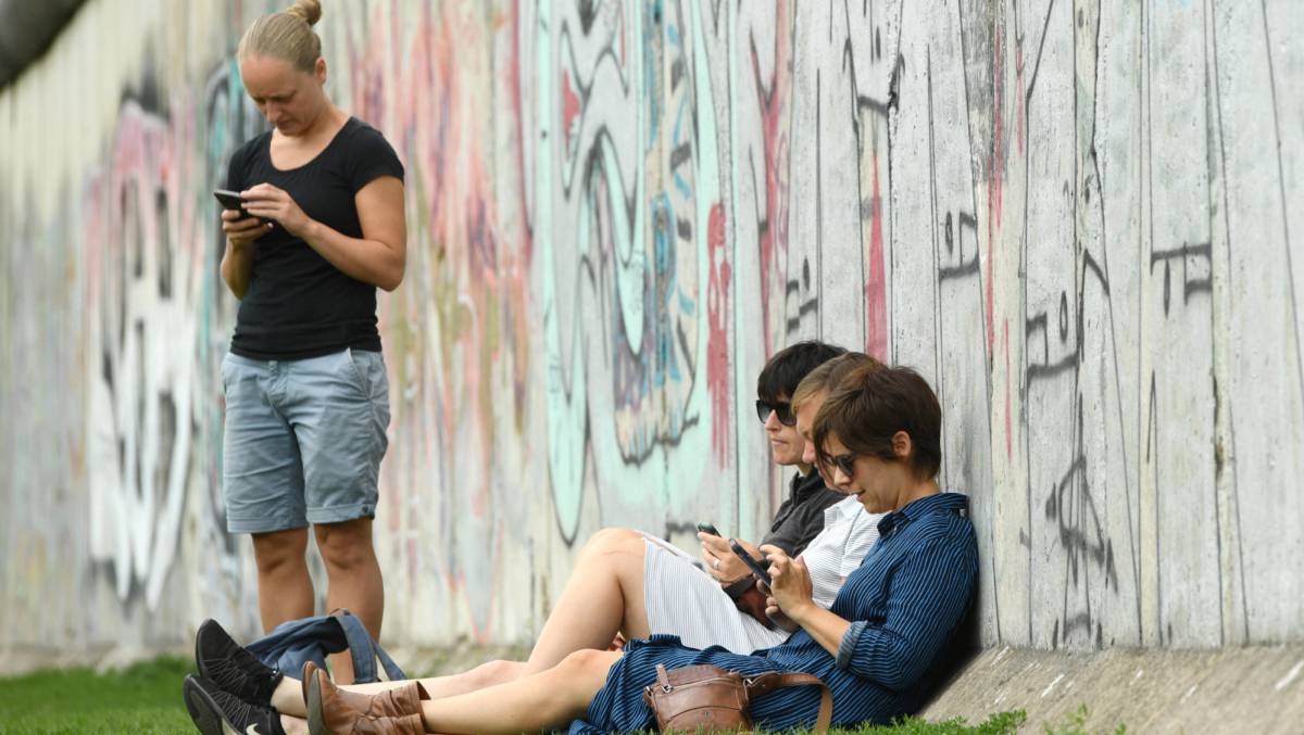 Un grupo de personas usa su móvil en Berlín.