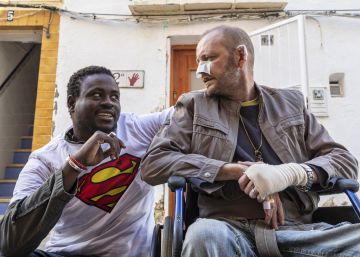 El senegalés Gorgui Lamine Sow y el hombre al que salvó Alex Caudeli, este martes, frente a la casa incendiada.