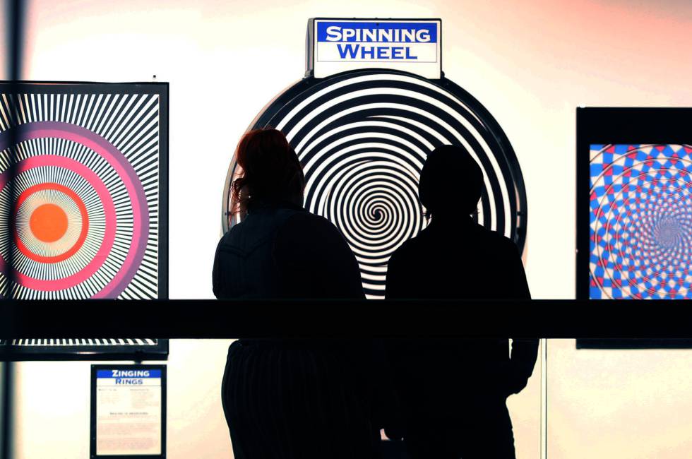 Two people gaze at the 'Seeing is Deceiving' (Sight Deceives) installation at the Science Museum.
