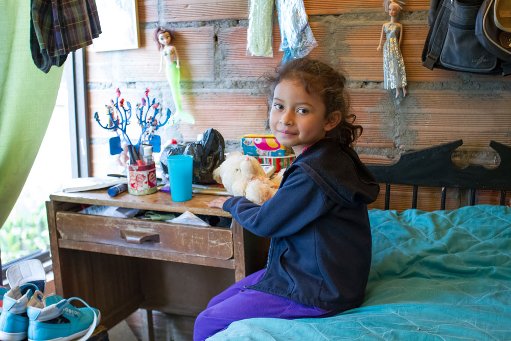 Una de las hijas de John Usuga y Gloria en la habitación de su casa
