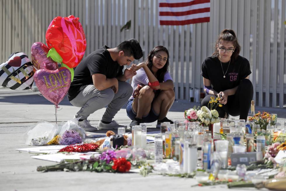 Personas rezan frente a las ofrendas por el tiroteo de Las Vegas.