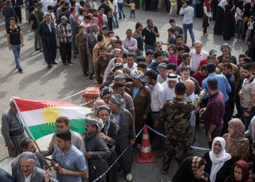 Un grupo de personas espera la apertura de un centro electoral, en Erbil