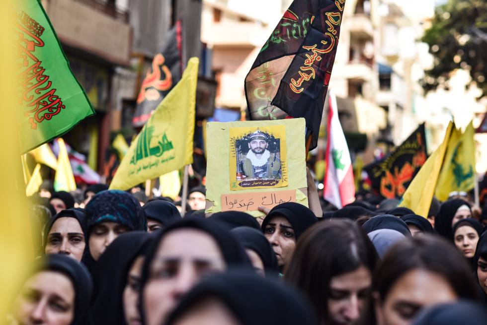 Una mujer sostiene la imagen un miliciano de Hezbolá muerto combatiendo en Siria, durante una concentración el pasado domingo en Dahie, periferia de Beirut