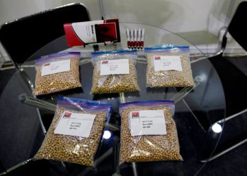 FILE - In this April 12, 2018, file photo, packets of raw soybeans are placed on a table at a U.S. soybean company's booth at the international soybean exhibition in Shanghai, China. China has announced some U.S. industrial chemicals will be exempt from tariff hikes imposed in a trade war with Washington but maintained penalties on soybeans, pork and other farm goods. The Ministry of Finance's announcement Wednesday, Sept. 11, 2019 came ahead of October talks aimed at ending the fight over trade and technology that threatens global economic growth. (AP PhotoAndy Wong, File)