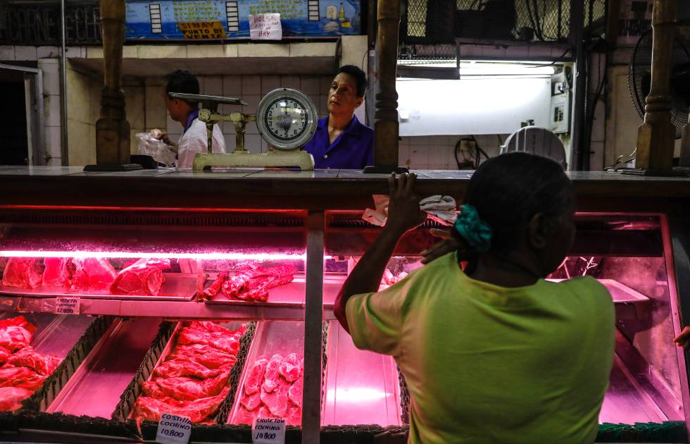 Una mujer compra carne en un establecimiento de Carcas.