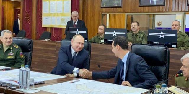 Vladímir Putin y Bachar el Asad estrechan sus manos, este martes en Damasco.
