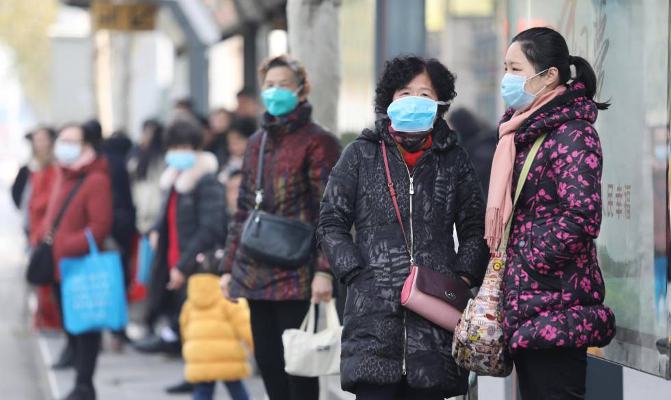 Vecinos de la localidad china de Wuhan se protegen con mascarillas.
