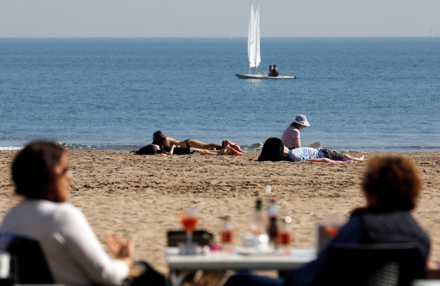 Varias personas disfrutan del buen tiempo y de las altas temperaturas en la playa de la Malvarrosa (Valencia) este viernes 22 de febrero